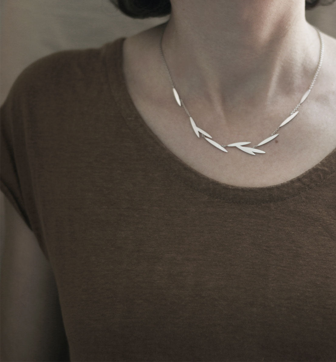 Un bijou unique de créateur. Un collier en argent massif avec des motifs de feuille sur une chaine, inspiré des graines de graminée. Les bijoux Histoire Botanique sont fabriqués par un artisan français.